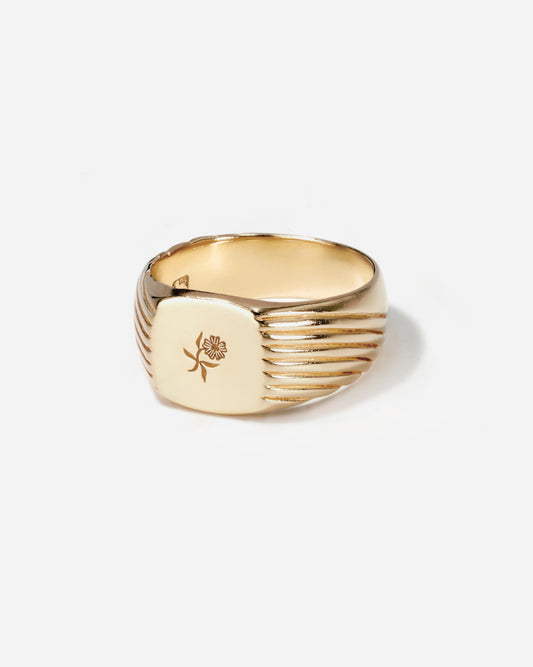 Gold mens signet ring with a flower by the mens jewelry brand BØME