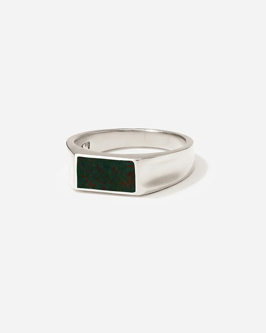 The Vale Stone Ring with its distinctive concave sides features a custom cut bloodstone ;Taking inspiration from a vale, a tranquil valley embraced by nature, its design portrays a serene and unpretentious charm and elegance.