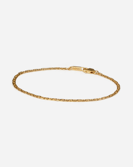 Gold flat mariner chain bracelet for men by BØME, showcasing a sleek, contemporary design with flat, interlocking links that offer both durability and elegance. The polished gold finish adds a bold, masculine touch, making it a versatile accessory for any occasion.